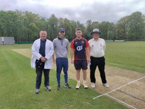 Two umpires and two captains after the toss